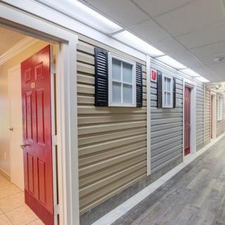 A uniquely designed interior hallway with doors and windows resembling an exterior home facade.