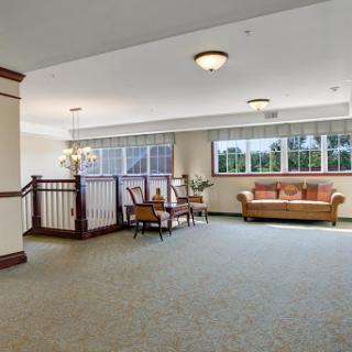 A spacious and well-lit lobby featuring comfortable seating and large windows.