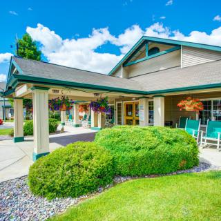 A well-maintained building with lush landscaping and a covered entrance.