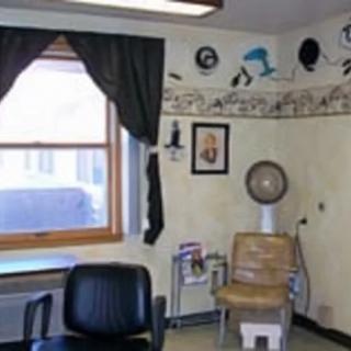 A cozy barbershop interior with chairs and wall decorations.