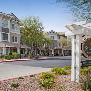 A modern residential building with a welcoming entrance and landscaped surroundings.