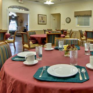 A dining room with neatly arranged tables and place settings.