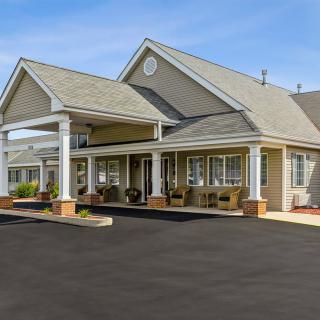 A large residential building with a porch and covered entrance.