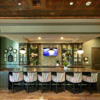 A modern bar interior with stylish seating and warm lighting.