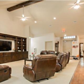 Cozy living room with leather seating and a large television.