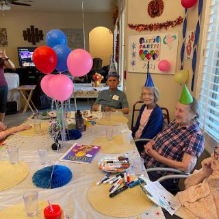 A joyful birthday celebration with friends and colorful decorations.