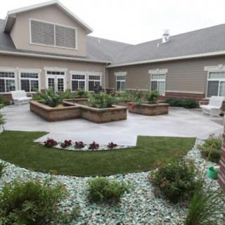 A beautifully landscaped courtyard with raised garden beds and lush greenery.
