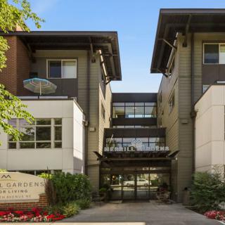A modern residential apartment complex with a central entrance and contemporary design.