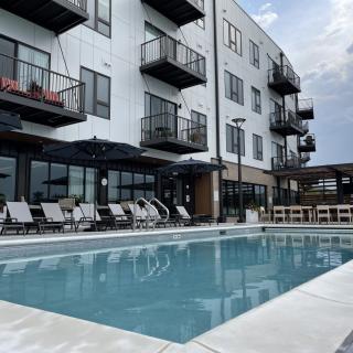 Modern apartment complex with a swimming pool and balconies.