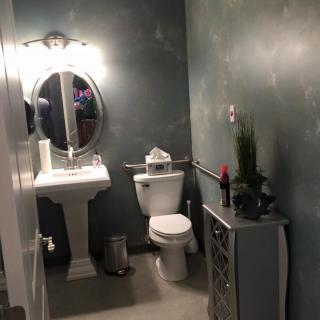 A modern bathroom with a pedestal sink and stylish decor.