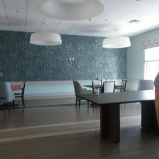 A spacious and modern dining area featuring stylish furniture and ambient lighting.