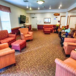 A cozy living room with comfortable chairs and a television.