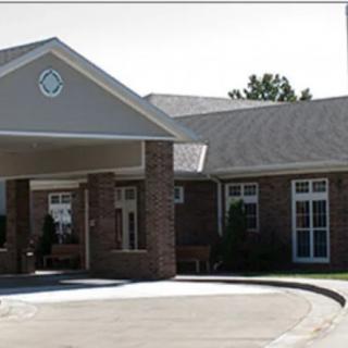 A front view of a brick residential building with a covered entrance.