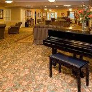 A cozy lobby area featuring a piano and comfortable seating.