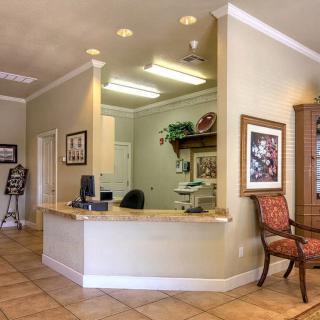 A welcoming reception area with a desk, computer, and comfortable seating.