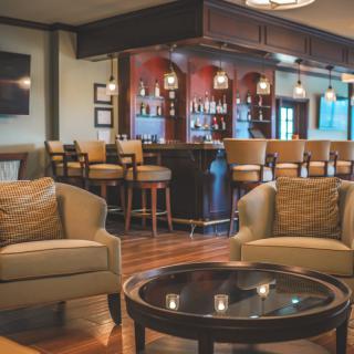 A cozy lounge area with comfortable seating and a well-stocked bar.