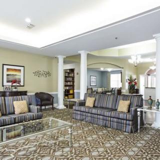 Elegant living room with stylish furniture and decorative columns.