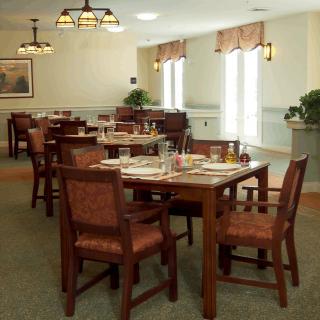 An empty dining area with neatly arranged tables and chairs.