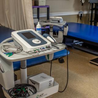 A physical therapy clinic with equipment and treatment table.