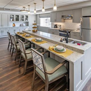 A modern kitchen with a spacious island and elegant seating.