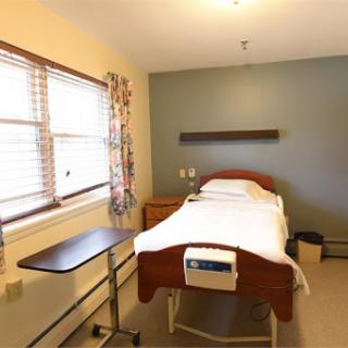 A simple and clean hospital patient room designed for comfort and recovery.