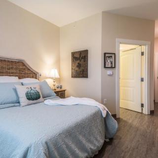 A cozy bedroom with a wicker headboard and soft lighting.