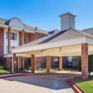 A welcoming entrance to a residential building with a covered carport.
