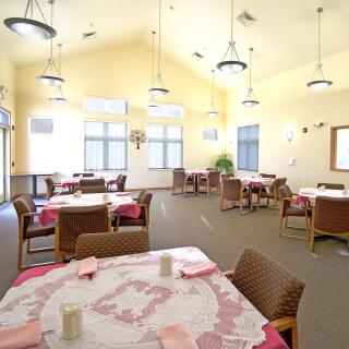 A spacious, well-lit dining area with neatly arranged tables and chairs.