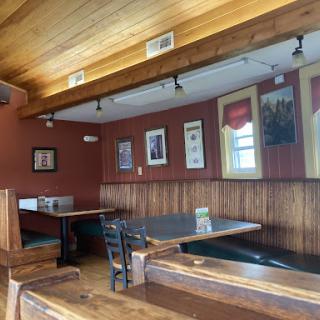 A cozy dining corner featuring wooden accents and framed artwork.