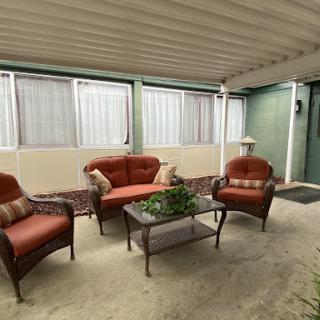 A cozy patio setup featuring comfortable seating and a decorative table.