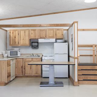 A modern kitchen featuring wooden cabinets and essential appliances.