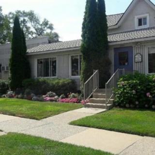 A charming residential house with well-maintained landscaping and garden.