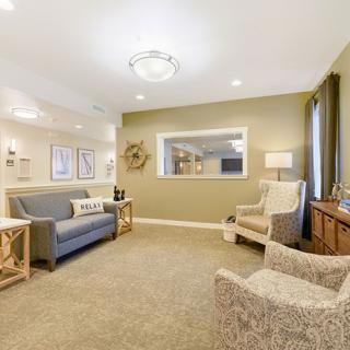 A cozy living room with comfortable seating, stylish decor, and warm lighting.