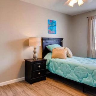 A cozy bedroom with a single bed, nightstand, and decorative elements.