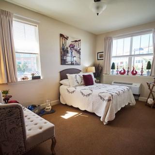 A cozy bedroom with ample natural light and tasteful decor.