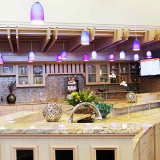 A modern kitchen interior featuring a stylish countertop and pendant lighting.
