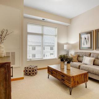 A cozy and stylish living room featuring a comfortable sofa, elegant coffee table, and abundant natural light.