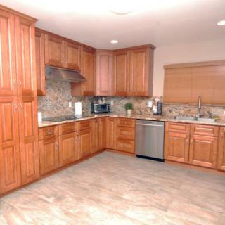 A modern kitchen with wooden cabinets and stainless steel appliances.