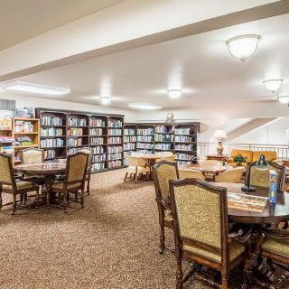 A cozy library room with bookshelves and reading tables.