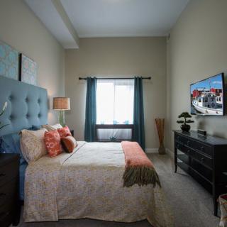A cozy bedroom with elegant decor and ample natural light.