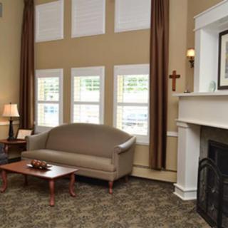 A cozy living room with a sofa, coffee table, and fireplace.