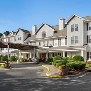 Front exterior view of a hotel with landscaped entrance.