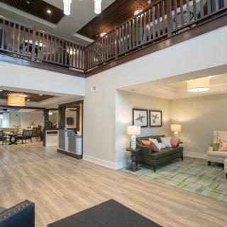 A spacious and elegantly designed living area with modern furniture and sophisticated lighting.