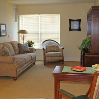 A cozy living room featuring a comfortable sofa, an armchair, and a warm ambiance.