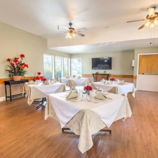 A well-decorated dining area with tables set for a gathering.