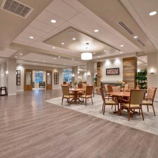A modern and spacious dining area with elegant lighting and wooden flooring.