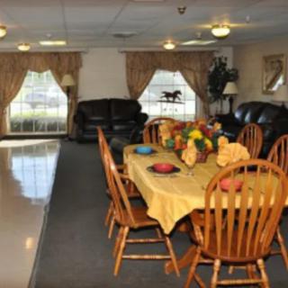 Cozy dining room with a large table set for a gathering and comfortable seating area.