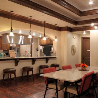 A cozy dining area featuring modern furnishings and warm lighting.
