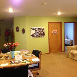 A cozy living and dining area with a table, chairs, and vibrant wall colors.