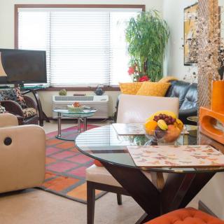 A modern living room with vibrant decor and comfortable seating.